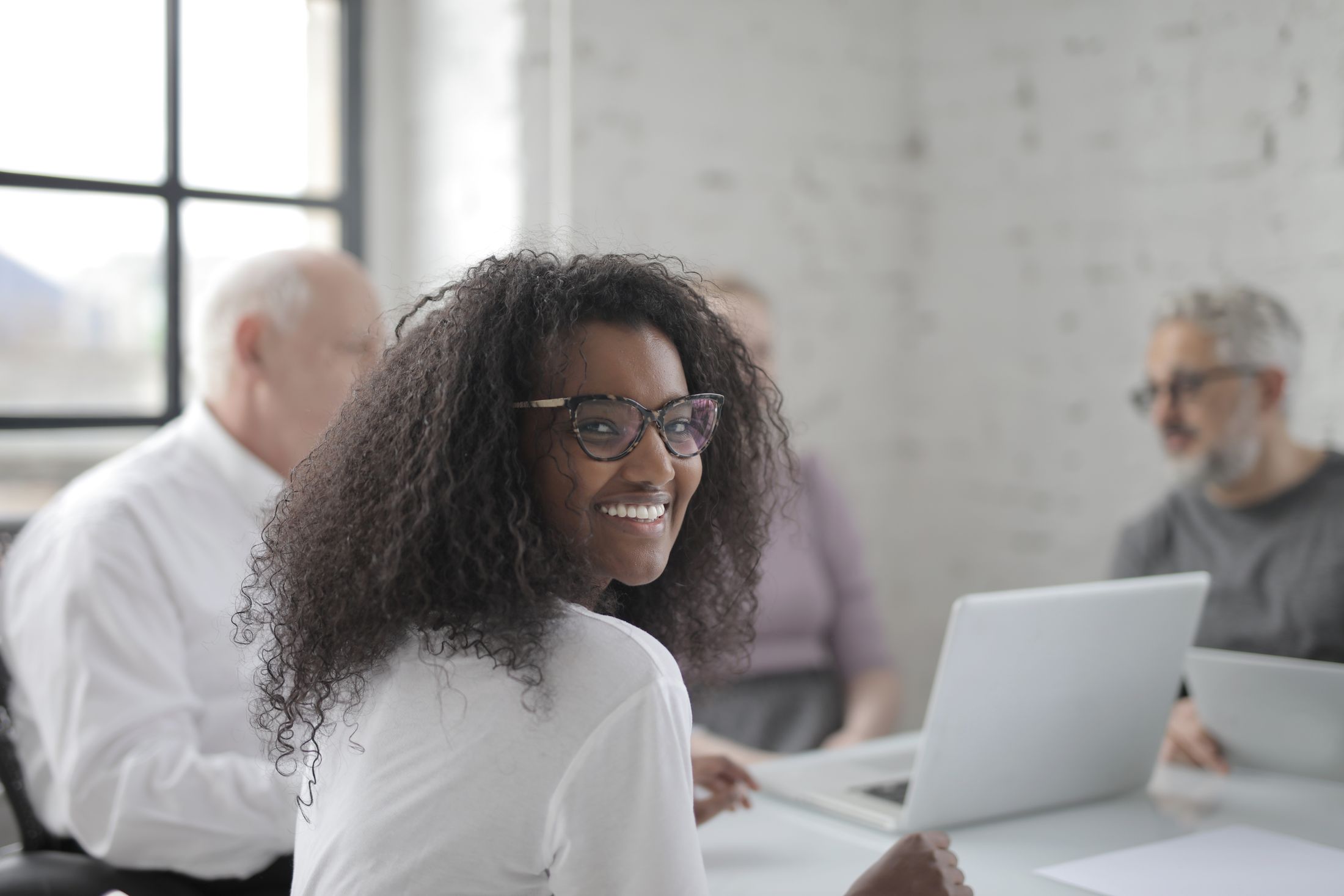 Payroll professionals working together in a bright office